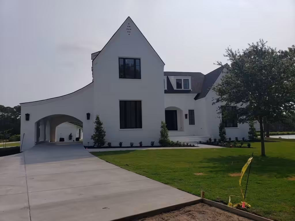Front Door Paint Colors for Charleston Homes: Choosing by House, Sun and Door White modern farmhouse with a steep gable, black-framed windows, an arched carport opening and a dark front door set into a recessed arched entry